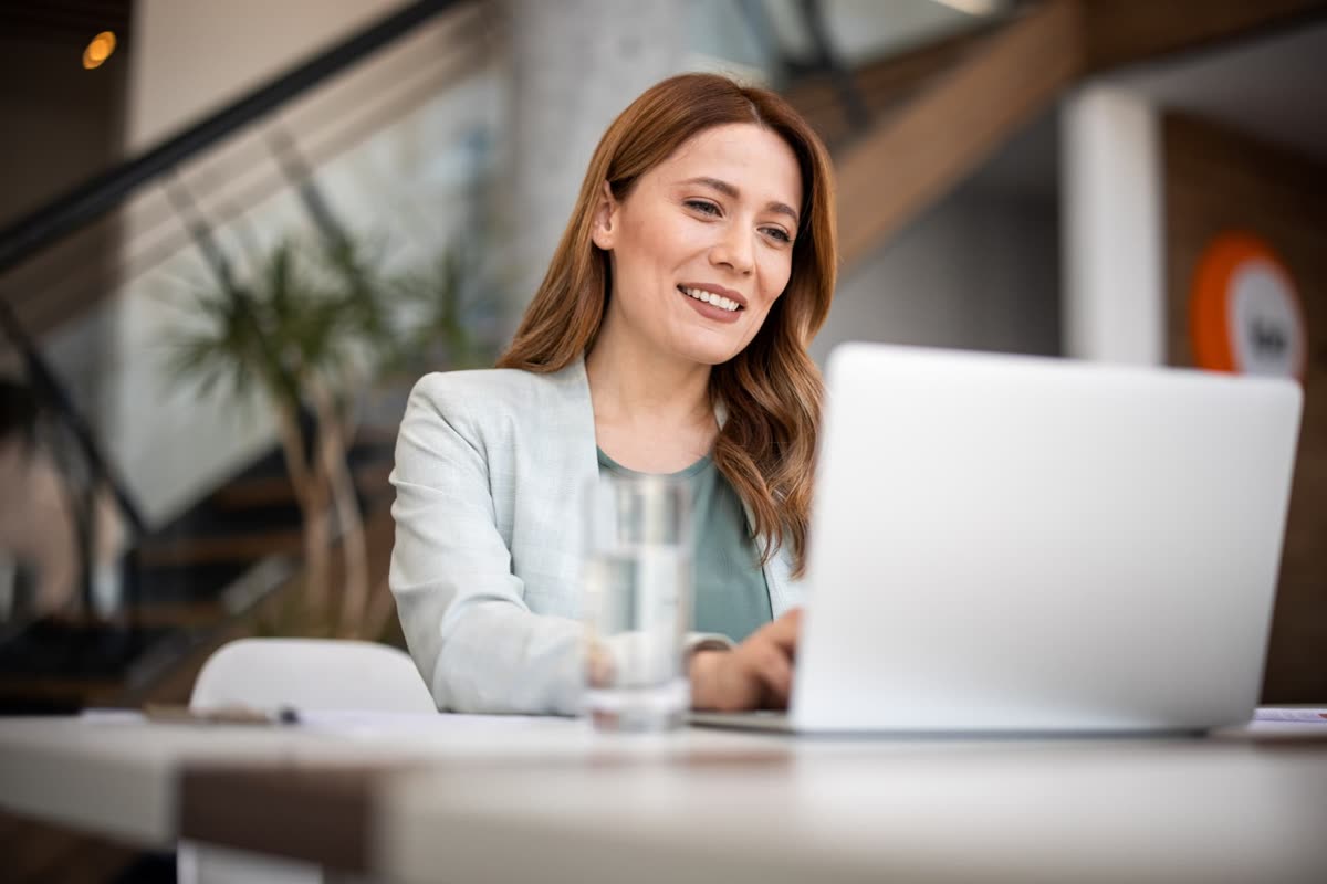 A channel partner reviewing her vendor programmes on a laptop.